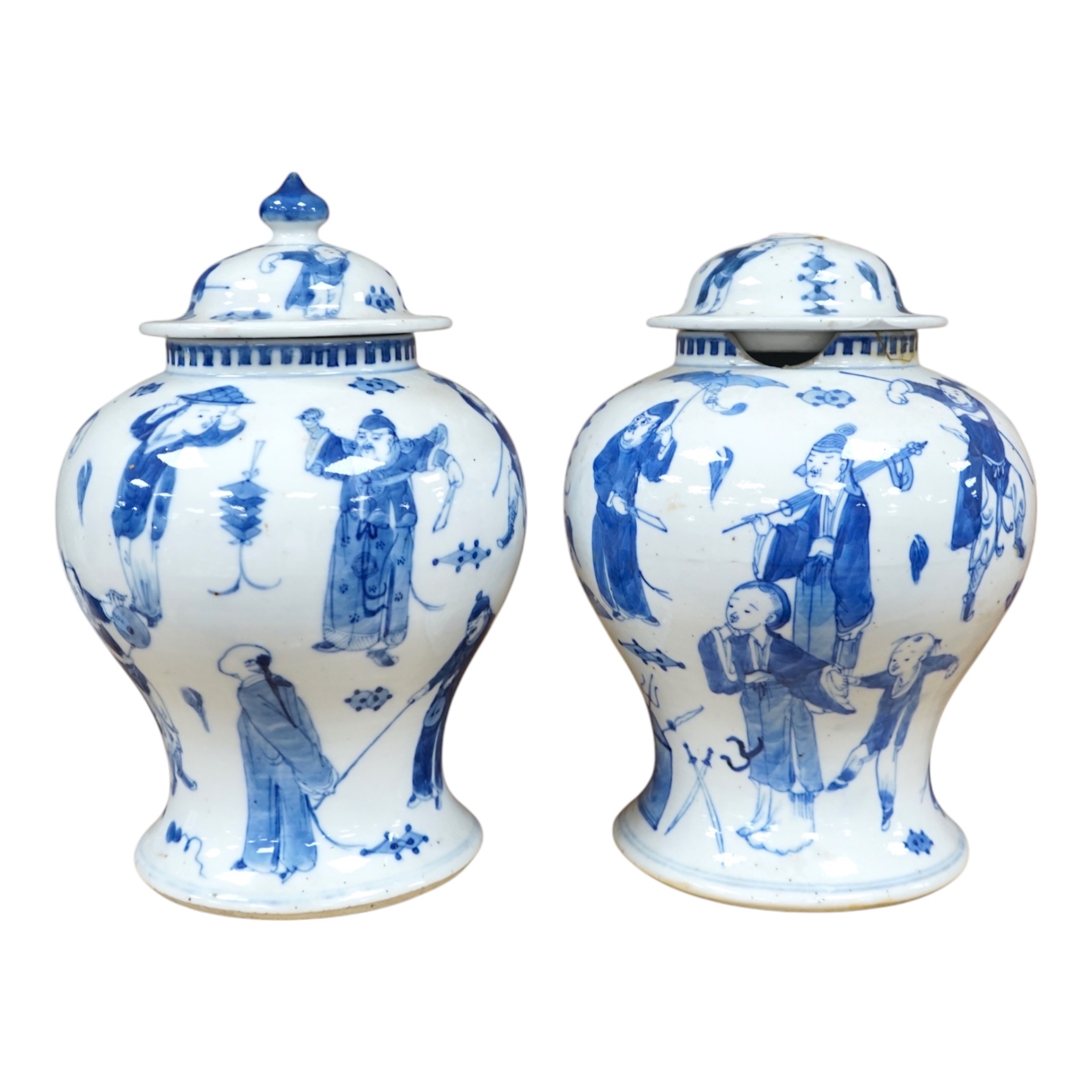 A pair of Chinese blue and white ‘street performers’ baluster vases, circa 1900, 25cm. 25.5cm. Condition - damaged